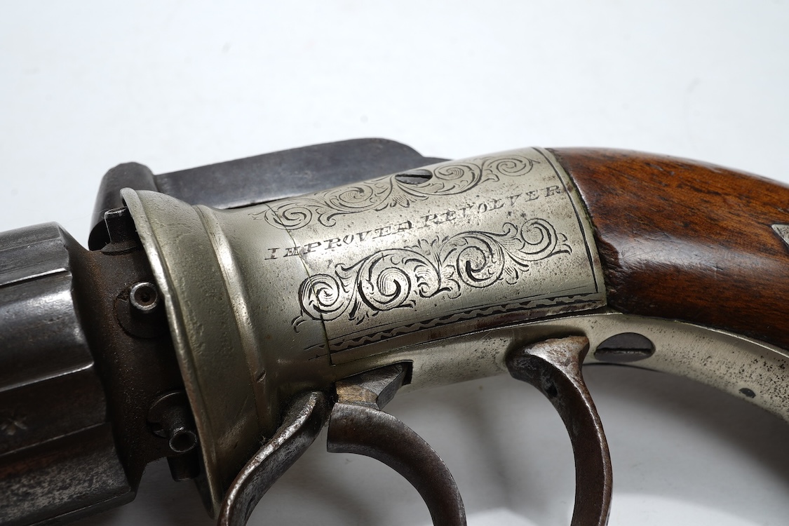 A six shot 120 bore self-cocking percussion pepperbox revolver with fluted barrels, Birmingham proof, rounded foliate engraved frame with ‘Improved Revolver’, and two-piece walnut grips